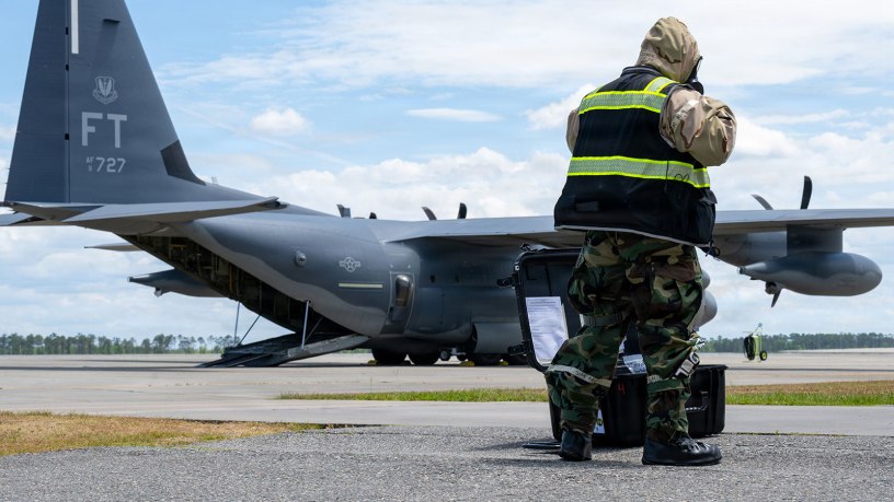 U.S. Air Force aircrew flight equipment specialists, helps assemble a decontamination line while waiting for aircrew to exit an HC-130 Combat King II during Toxic Magnolia, at Moody Air Force Base, Georgia, April 30, 2026. The training emphasized rapid setup and seamless integration with arriving aircraft to maintain mission continuity. (U.S. Air Force photo by Airman 1st Class Noah Noonan)