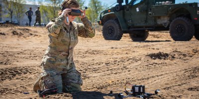 Pfc. Hailey Paton, an infantryman assigned to Echo Troop, 2nd Squadron, 2nd Cavalry Regiment, dons first-person view goggles before operating a small unmanned aerial system during Project FlyTrap 5.0 at Pabradė Training Area, Lithuania, May 2, 2026. FlyTrap directly supports the Eastern Flank Deterrence Initiative by evaluating scalable counter-drone solutions that can integrate into NATO's existing air defense networks. (U.S. Army photo by Sgt. Max Elliott)