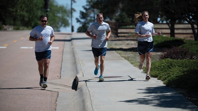U.S. Air Force Capt. Jason Engel, Staff Sgt. William Lipscomb, and Tech. Sgt. Alyson McCormack run during the 2026 Port Dawg Memorial Run at Peterson Space Force Base, Colo., May 2, 2026. The annual event honored fallen Airmen from the aerial port community by bringing together service members for a memorial run. (U.S. Air Force photo by Senior Airman John Lewis IV)