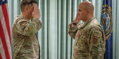 Maj. Joel Loranger, the operations officer for the 157th Security Forces Squadron, salutes Maj. Michael Petrin, commander of the 157th SFS, at a recognition ceremony May 2, 2026 at Pease Air National Guard Base, New Hampshire. Loranger was awarded the Bronze Star Medal for distinguished accomplishments while deployed to Iraq, where he led security forces through a series of enemy aerial attacks during a six-month combat tour. (U.S. Air National Guard photo by Tech. Sgt. Timothy Hayden)