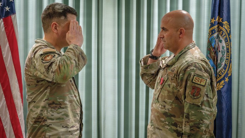 Maj. Joel Loranger, the operations officer for the 157th Security Forces Squadron, salutes Maj. Michael Petrin, commander of the 157th SFS, at a recognition ceremony May 2, 2026 at Pease Air National Guard Base, New Hampshire. Loranger was awarded the Bronze Star Medal for distinguished accomplishments while deployed to Iraq, where he led security forces through a series of enemy aerial attacks during a six-month combat tour. (U.S. Air National Guard photo by Tech. Sgt. Timothy Hayden)