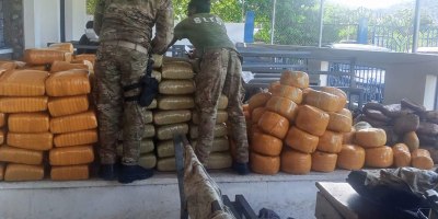 Haitian National Police members inspect interdicted drugs following a drug interdiction off Haiti, May 3, 2026. At the behest of the Haitian government, a U.S. Coast Guard law enforcement detachment deployed on the USS Billings stopped a suspected drug vessel carrying approximately 3,200 pounds of marijuana. (U.S. Coast Guard photo)