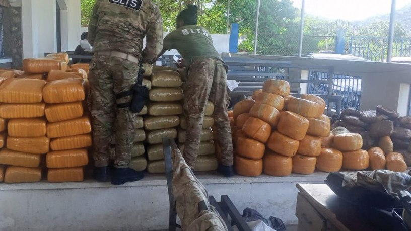 Haitian National Police members inspect interdicted drugs following a drug interdiction off Haiti, May 3, 2026. At the behest of the Haitian government, a U.S. Coast Guard law enforcement detachment deployed on the USS Billings stopped a suspected drug vessel carrying approximately 3,200 pounds of marijuana. (U.S. Coast Guard photo)