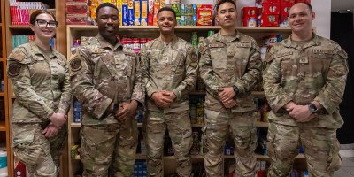U.S. Air Force Airmen assigned to the 31st Fighter Wing pose for a group photo during the Food Pantry opening on Aviano Air Base, Italy, May 4, 2026. These volunteers helped to set up, organize and obtain supplies for the food pantry. (U.S. Air Force photo by TaeLani Allen-Lewis)
