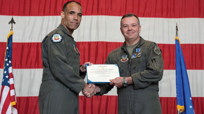 U.S. Air Force Gen. Adrian Spain, commander of Air Combat Command, presents Lt. Col. Christopher M. Beckett, an F-16 Fighting Falcon pilot and 55th Fighter Squadron commander, with the Distinguished Flying Cross during a ceremony at Shaw Air Force Base, South Carolina, May 5, 2026. Beckett received the decoration for the heroism and bravery he exemplified while flying during Operation Midnight Hammer. (U.S. Air Force photo by Senior Airman Nyanda Walker-Potts)