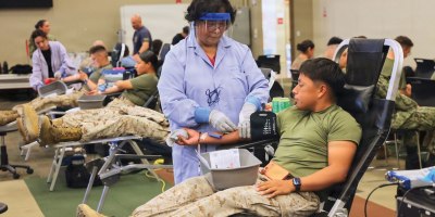 A Marine donates blood during a record-breaking Armed Services Blood Program blood drive at Marine Corps Air Ground Combat Center Twentynine Palms, May 6, 2026. The blood drive collected 117 units of blood in support of military operations overseas, setting a new installation record for collections during a single event. (U.S. Navy photo by Christopher Jones