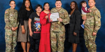 U.S. Army Staff Sgt. Julio Hernandez, center, holds a Volunteer of the Month certificate alongside family members and fellow Soldiers after being recognized as the Anne Arundel County Public Schools’ (AACPS) Volunteer of the Month for May 2026 during a ceremony held on Ft. Meade, Md., May 7, 2026. Staff Sgt. Hernandez has spent over two years volunteering with the community. (Courtesy photo by U.S. Army Staff Sgt. Julio Hernandez and AACPS)