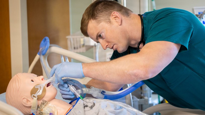 U.S. Navy Lt. j.g. Mathew Rasmussen checks a simulated patient's airway during the final simulation exercise of the inaugural Navy Critical Care Course at Walter Reed National Military Medical Center, Bethesda, Md., May 8, 2026. Walter Reed is the host site for the U.S. Navy's first standardized critical care nursing course, offered across the Defense Health Agency. (DOW photo by Ricardo J. Reyes)