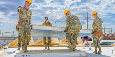 Soldiers assigned to the Wyoming Army National Guard’s 307th Engineer Utilities Detachment carry a wall during a two-week Innovative Readiness Training project providing military engineer training while helping construct homes for local residents in Cheyenne, Wyoming, May 9, 2026. Partnered with Habitat for Humanity, the project is part of the Department of Defense Innovative Readiness Training program, which allows military units to support community organizations while conducting mission-essential engineer training. (U.S. Army National Guard photo by Sgt. 1st Class Cesar Rivas)