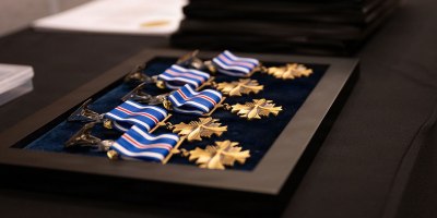 Distinguished Flying Cross medals set on table for presentation during a Distinguished Flying Cross ceremony at RAF Mildenhall, England, May 11, 2026. The award recognizes heroism or extraordinary achievement while participating in aerial flight and honors those whose actions go beyond the demands of duty during combat or active operations against an armed enemy. (U.S. Air Force photo by Airman 1st Class Iris Carpenter)