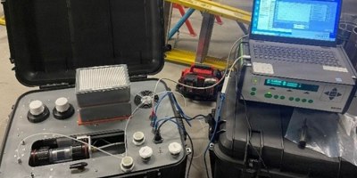 A Residual Life Indicator Sampling Cartridge Analysis System conducts a test on a RLI Satellite Cartridge System cartridge.