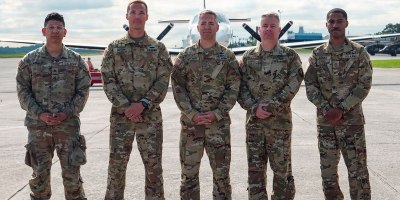 Five deploying members of Bravo Company, 245th Aviation Regiment, Georgia National Guard, stand together in front of a C-26 Metroliner aircraft prior to a takeoff for a deployment, Dobbins Air Reserve Base, Georgia, May 13, 2026. Soldiers from the Georgia Army National Guard departed today for a deployment to Djibouti, where they will provide critical fixed-wing aviation support across the Horn of Africa. (U.S. Air National Guard photo by Staff Sgt. Josiah Meece).