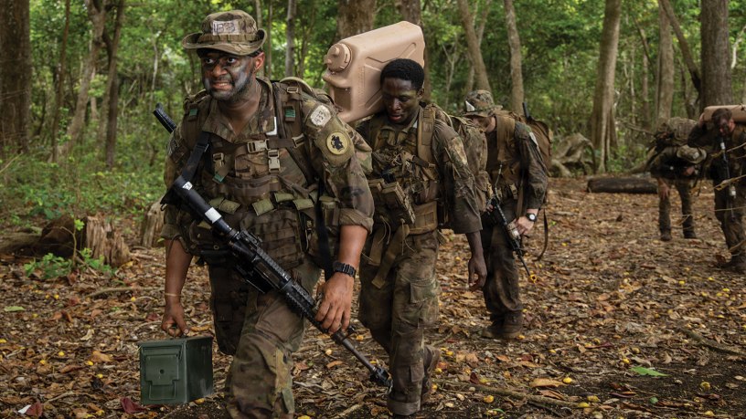 U.S. service members and Panamanian partners move through the jungle while carrying equipment and supplies during the Green Mile event as part of the Jungle Operations Training Course–Panama at Aeronaval Base Cristóbal Colón, Panama, May 14, 2026. The training strengthened interoperability and reinforced the enduring partnership between U.S. forces and Panamanian security institutions through combined jungle operations in a demanding tropical environment. (U.S. Army photo by Sgt. Nirak Garcia Navarro)