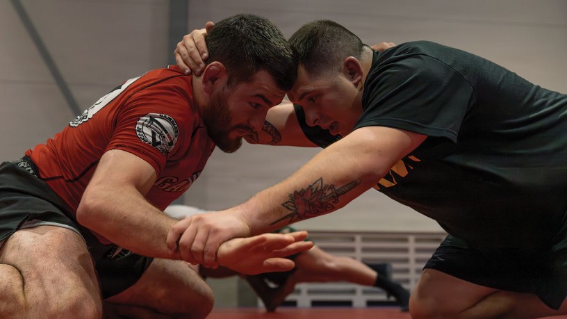 Professional mixed martial arts fighter Jose “Shorty” Torres, left, grapples with Sgt. Aaron Kaczur, assigned to the 196th Mobile Public Affairs Detachment, right, during a mixed martial arts clinic at Tapa Army Base, Estonia, May 15, 2026.