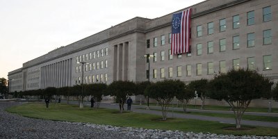 An American flag unfurls down the side of the Pentagon to celebrate Armed Forces Day and honor America's 250th birthday, May 16, 2026. The Betsy Ross flag features 13 white stars in a circle on a blue field with 13 alternating red and white stripes, symbolizing the original colonies.