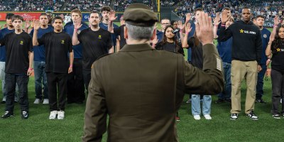 Lt. Gen. Matthew W. McFarlane, commanding general of I Corps and Joint Base Lewis-McChord, Washington, administers the oath of enlistment to more than 100 future service members on the field at T-Mobile Park during the Seattle Mariners’ Salute to Armed Services Night before a game against the San Diego Padres.