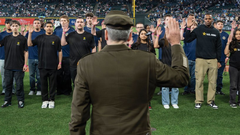Lt. Gen. Matthew W. McFarlane, commanding general of I Corps and Joint Base Lewis-McChord, Washington, administers the oath of enlistment to more than 100 future service members on the field at T-Mobile Park during the Seattle Mariners’ Salute to Armed Services Night before a game against the San Diego Padres.