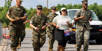 U.S. Marines motivate Gaby Trujillo, one of the final runners for the Historic Half, during the 2026 Marine Corps Historic Half in Fredericksburg, Virginia, May 17, 2026. The Historic Half is a 13.1-mile race weaved throughout Historic Downtown Fredericksburg, home to over 200 businesses and several historic sites.