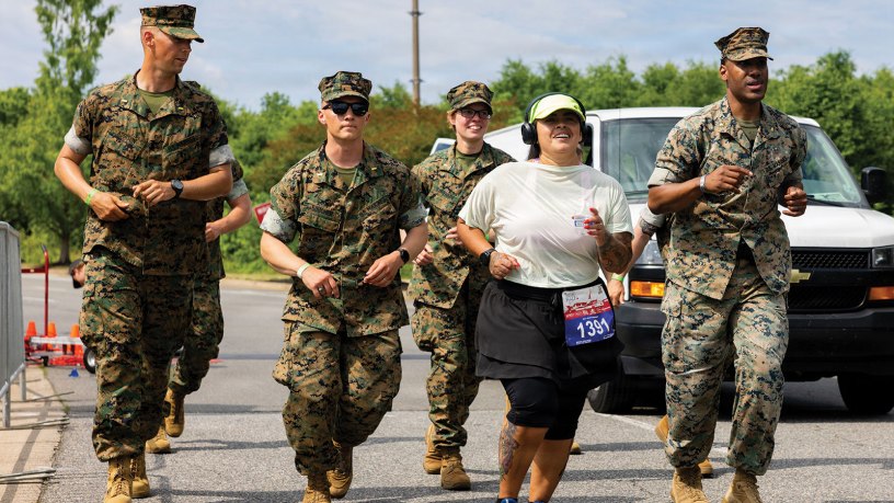 U.S. Marines motivate Gaby Trujillo, one of the final runners for the Historic Half, during the 2026 Marine Corps Historic Half in Fredericksburg, Virginia, May 17, 2026. The Historic Half is a 13.1-mile race weaved throughout Historic Downtown Fredericksburg, home to over 200 businesses and several historic sites.