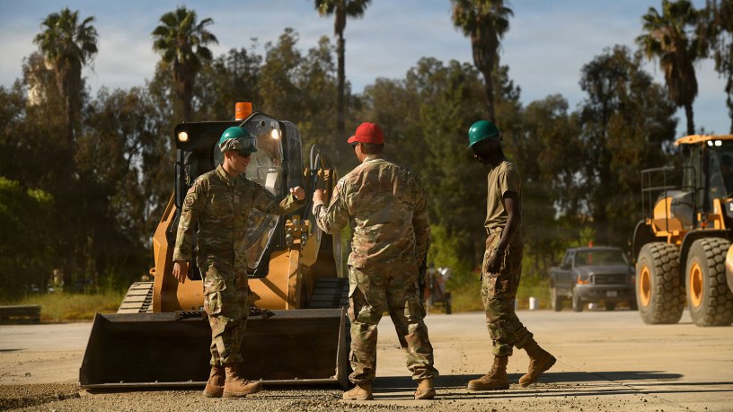 U.S. Air Force Senior Master Sgt. Reuben Dominguez, 163d Regional Training Site superintendent, California Air National Guard, gives kudos to Airmen after operating a skid-steer successfully during a weeklong Rapid Damage Repair course at March Air Reserve Base, California, May 19, 2026. Airmen learn to execute full-scale crater repair procedures, beginning with debris removal and upheaval marking before progressing through excavation, backfilling, compaction and surface restoration. Photo by Senior Master Sgt. Julianne Sitterding.