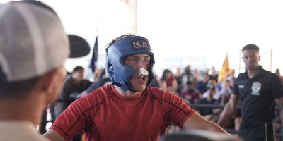Spc. Robert Veleber, a Soldier assigned to Headquarters and Headquarters Company, 1st Battalion, 67th Armor Regiment, 3rd Armored Combat Team, 1st Armored Division, takes his rest period in the corner to recover, receive a medical check, and get tactical adjustments from his coaching staff during Dealer Fight Night at Fort Bliss, Texas, May 19, 2026.