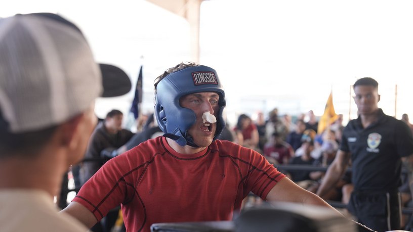Spc. Robert Veleber, a Soldier assigned to Headquarters and Headquarters Company, 1st Battalion, 67th Armor Regiment, 3rd Armored Combat Team, 1st Armored Division, takes his rest period in the corner to recover, receive a medical check, and get tactical adjustments from his coaching staff during Dealer Fight Night at Fort Bliss, Texas, May 19, 2026.