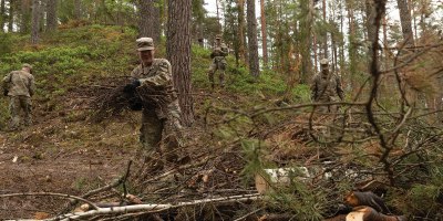 U.S. Army Spc. Ryan Llewellyn, assigned to Charlie Troop, 4th Squadron, 9th Cavalry Regiment, throws debris into a pile as a part of the Estonian Defence Force memorial restoration day at Lounalaagri Lõkkekoht in Võru, Estonia, May 20, 2026.
