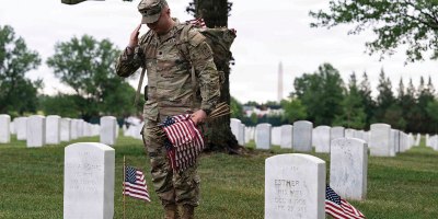 Soldiers assigned to the 3rd U.S. Infantry Regiment place American flags at every gravesite at Arlington National Cemetery, Va., May 21, 2026.