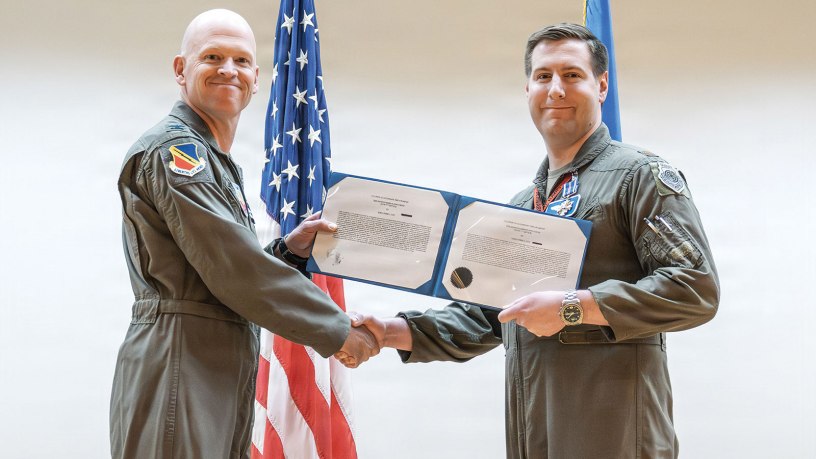 Col. Christipher Hubbard, acting 388th Fighter Wing commander presents the Distinguished Flying Cross to Maj. Alexander Cox during a ceremony at Hill Air Force Base, Utah, May 21, 2026. Cox also received a Bronze Star. Both decorations were awarded for actions during a 2025 deployment to the United States Central Command area of responsibility, including participation in Operation Midnight Hammer. (U.S. Air Force photo by Cynthia Griggs)