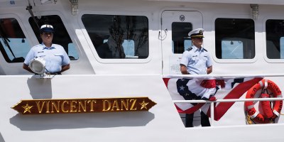 U.S. Coast Guard crew members stand at parade rest while lining the rails aboard USCGC Vincent Danz (WPC 1162) during the cutter’s commissioning ceremony at Pier 86 near the Intrepid Museum in New York, May 22, 2026. The ceremony formally placed the cutter into active Coast Guard service. (U.S. Coast Guard photo by Seaman Braelynn Greene)