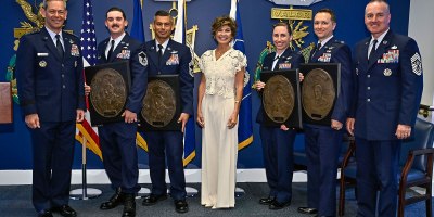 Air Force Chief of Staff Gen. Ken Wilsbach, left, Master Sgt. Steven Nelson, Chief Master Sgt. William Brakebill, Janine Sijan, Capt. Megan Langas, Maj. Joe Goliber and Chief Master Sgt. of the Air Force David Wolfe pose during a ceremony at the Pentagon in Arlington, Va., May 26, 2026. Nelson, Brakebill, Langas and Goliber were presented the Lance P. Sijan Award for leadership. (U.S. Air Force photo by Eric Dietrich)