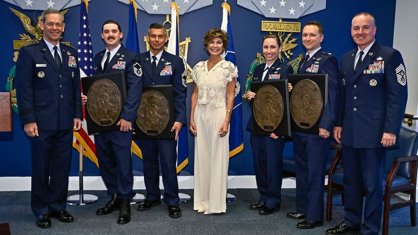 Air Force Chief of Staff Gen. Ken Wilsbach, left, Master Sgt. Steven Nelson, Chief Master Sgt. William Brakebill, Janine Sijan, Capt. Megan Langas, Maj. Joe Goliber and Chief Master Sgt. of the Air Force David Wolfe pose during a ceremony at the Pentagon in Arlington, Va., May 26, 2026. Nelson, Brakebill, Langas and Goliber were presented the Lance P. Sijan Award for leadership. (U.S. Air Force photo by Eric Dietrich)