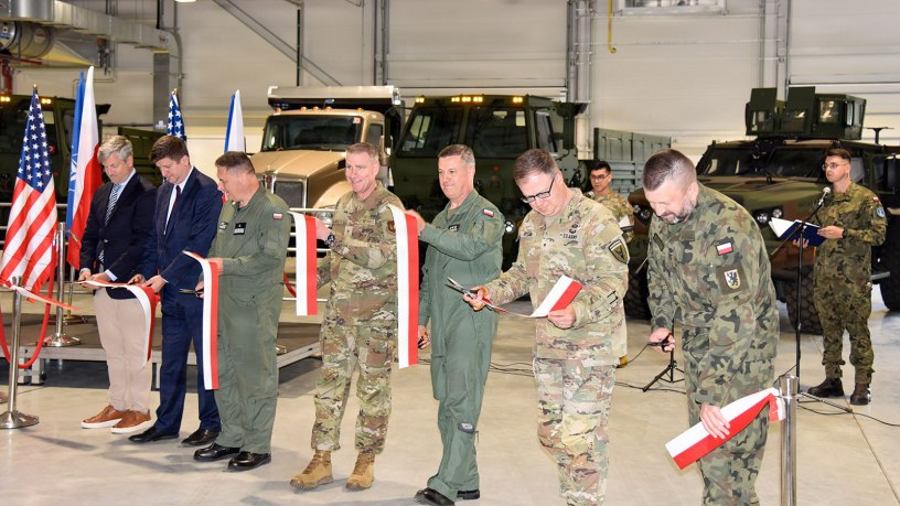 Polish and U.S. military officials cut the ceremonial ribbon together celebrating the completion of the Deployable Air Base System Facilities, Equipment and Vehicle storage site in Powidz, Poland May 27, 2026. The DABS-FEV will store the essentials to make it faster for the U.S. Air Force and NATO Allies to quickly set up and operate from air bases in and around Poland. (U.S. Army photo by Chris Gardner)