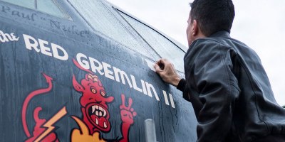U.S. Air Force Capt. Kerry Baker applies nose art on a 93rd Bomb Squadron B-52H Stratofortress, Nov. 15, 2013, Barksdale Air Force Base, La. The original "Red Gemlin" nose art was on a World War II B-17 bomber piloted by now retired Gen. Paul Tibbets, Jr. U.S. Air Force photo by Master Sgt. Greg Steele.