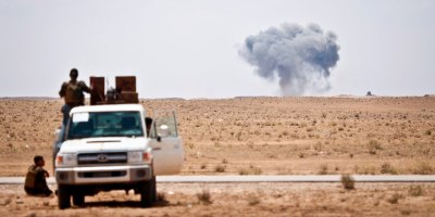 Syrian Democratic Forces watch as a Coalition airstrike hits its target on a known ISIS location near the Iraqi-Syrian border, May 13, 2018.