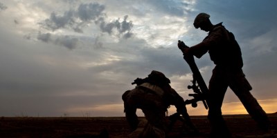 A Coalition member hangs an 81-millimeter mortar prior to launching it at a known ISIS location near the Iraqi-Syrian border, May 13, 2018. The Coalition provided fire support and air strikes to assist the Syrian Democratic Forces as they continued Operation Roundup, the military offensive to destroy ISIS and liberate all land east of the Euphrates River. (U.S. Army photo by Staff Sgt. Timothy R. Koster)