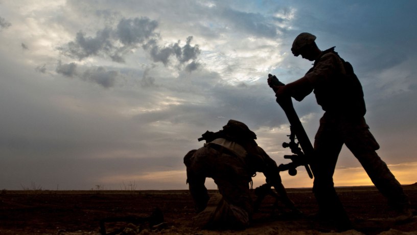 A Coalition member hangs an 81-millimeter mortar prior to launching it at a known ISIS location near the Iraqi-Syrian border, May 13, 2018. The Coalition provided fire support and air strikes to assist the Syrian Democratic Forces as they continued Operation Roundup, the military offensive to destroy ISIS and liberate all land east of the Euphrates River. (U.S. Army photo by Staff Sgt. Timothy R. Koster)