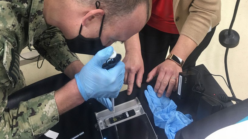 An end user loads a flow cell on a modified field sequencing device during Beholder’s Gaze training, Oct. 24, 2024.