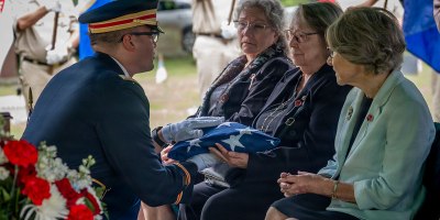 U.S. Army Capt. Christopher Barnabei, the Connecticut National Guard's casualty operations officer in charge, hands a folded American Flag to the family of U.S. Army Air Forces Tech. Sgt. Donald A. Dorman at his funeral services at Oak Hill Cemetery, Southington, Conn. June 23, 2026.