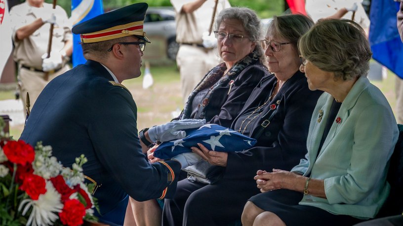 U.S. Army Capt. Christopher Barnabei, the Connecticut National Guard's casualty operations officer in charge, hands a folded American Flag to the family of U.S. Army Air Forces Tech. Sgt. Donald A. Dorman at his funeral services at Oak Hill Cemetery, Southington, Conn. June 23, 2026.