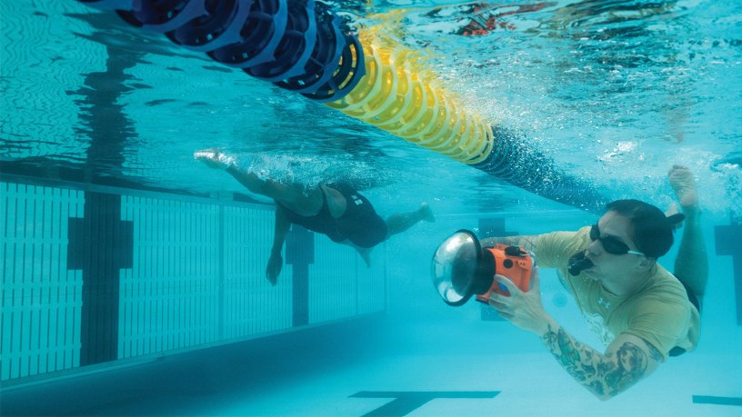 Tech. Sgt. Shawn White, 4th Combat Camera aerial combat camera craftsman, using an underwater housing to capture a new perspective during the swimming event of Warrior Games 2026.