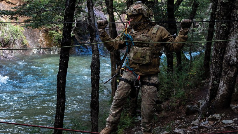 A U.S. Airman from the 492nd Special Operations Wing crosses a rope bridge over a river at the Escuela Militar de Montaña in Bariloche, Argentina on March 19, 2026. This training is vital for ensuring that both U.S. and Argentine forces are prepared to meet future security challenges together. (U.S. Air Force photo by Elizabeth Easterling)