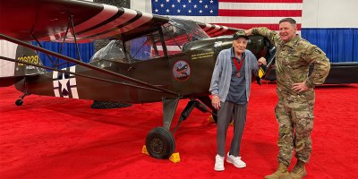 U.S. Army Reserve Brig. Gen. Stephen P. Case (right), commanding general of the 95th Training Division - Initial Entry Training, stands with World War II veteran Staff Sgt. Dominick Critelli next to a restored Taylorcraft L-2M Grasshopper liaison aircraft during the Army Aviation Warfighting Summit held April 15-17, 2026. (Courtesy photo)