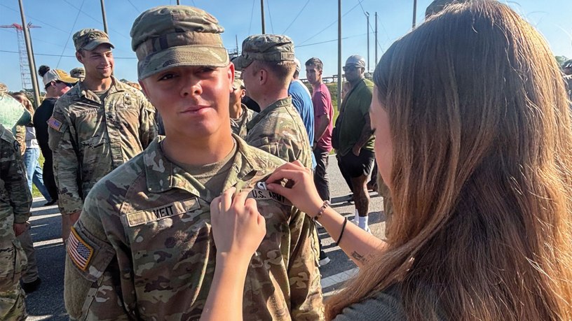 U.S. Army Pvt. 1st Class Mace Veit, 1st Battalion, 221st Cavalry, Nevada National Guard, is being pinned his airborne pin by his sister at Fort Benning, Georgia, April 17, 2026. Veit completed Ranger School, Airborne School, Air Assault School and Pathfinder School before his 20th birthday, accomplishing in less than six months what can take many Soldiers years to achieve. Courtesy photo.