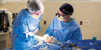 Third year medical student, U.S. Air Force 2nd Lt. Ashley Diekemper, left, assists U.S. Army Maj. Jonathan Buttram as he repairs a fractured eye socket at Walter Reed National Military Medical Center, Bethesda, Md., April 23, 2026.