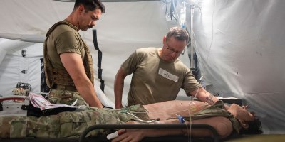U.S. Air Force chaplain, right, and religious affairs Airman simulate emotional support care during the Trauma Ministry Operations Course (TMOC) at Joint Base San Antonio-Camp Bullis, Texas, May 13, 2026. The TMOC course equips chaplains and religious affairs specialists to provide short-term trauma intervention, triage support, and spiritual care. (U.S. Air Force photo by Melissa Hydrick)
