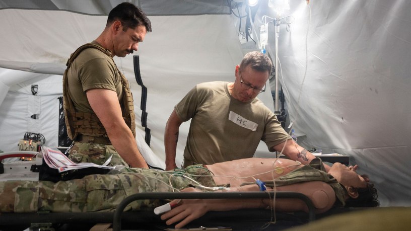 U.S. Air Force chaplain, right, and religious affairs Airman simulate emotional support care during the Trauma Ministry Operations Course (TMOC) at Joint Base San Antonio-Camp Bullis, Texas, May 13, 2026. The TMOC course equips chaplains and religious affairs specialists to provide short-term trauma intervention, triage support, and spiritual care. (U.S. Air Force photo by Melissa Hydrick)