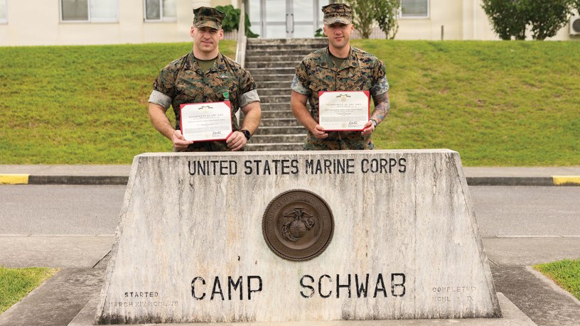 U.S. Marine Corps Staff Sgt. Zachary Robbin, right, an infantry platoon sergeant, and Navy Hospital Corpsman 1st Class Thomas Musumeci, a leading petty officer, both with 1st Battalion, 25th Marines, forward deployed to 4th Marine Regiment, 3rd Marine Division as part of the unit deployment program, pose for a photo with their Navy and Marine Corps Achievement Medals on Camp Schwab, May 14, 2026.