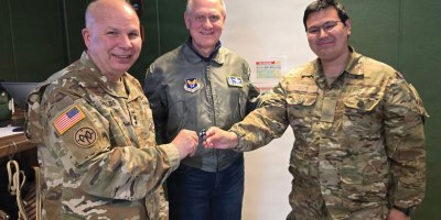 Major Gen. Ray Shields, the adjutant general of New York, left, and Richard Anderson, the Air Force’s assistant secretary for manpower and reserve affairs, present a challenge coin to Lance Corp. A.M. Sethsen, a Greenlandic member of the Danish Army, on May 19, 2026, in Kangerlaussauq Greenland.