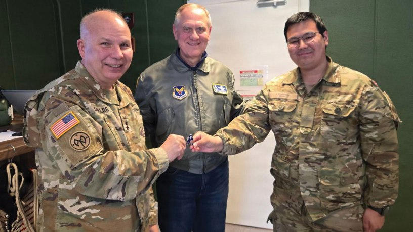 Major Gen. Ray Shields, the adjutant general of New York, left, and Richard Anderson, the Air Force’s assistant secretary for manpower and reserve affairs, present a challenge coin to Lance Corp. A.M. Sethsen, a Greenlandic member of the Danish Army, on May 19, 2026, in Kangerlaussauq Greenland.